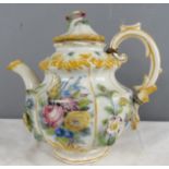 An Italian stoneware glazed miniature tea pot, modelled with flowers, 13½cm high, together with a