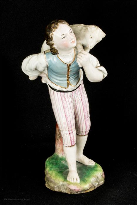 A Vienna porcelain 18th century figure of a shepherd carrying a lamb.