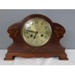 A mahogany marquetry mantle clock.