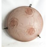 A vintage pink glass ceiling light, the shade modelled with roses.