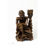 A Chinese carving of a seated man.