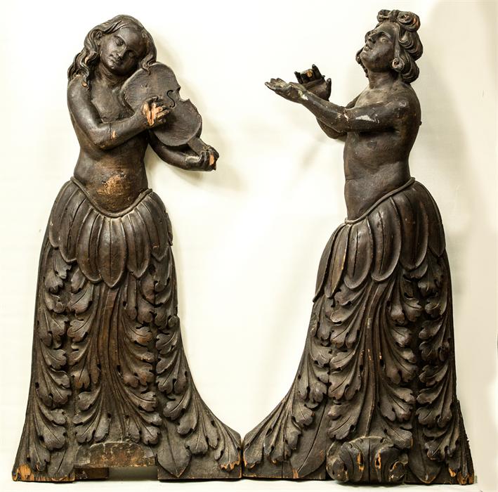 A pair of 18th century baroque carved figures, female figures, one playing a violin.