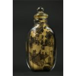 A Chinese scent bottle, black on gold ground.