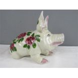 A Wiems type porcelain pig decorated with roses.