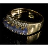 A 9ct gold ring with six oval cut tanzanite stones flanked by eight small diamonds, 4.5g