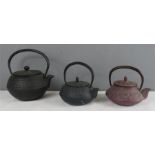 Three Japanese metalware tea pots, of various form and colour.