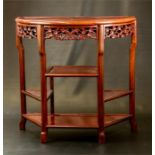 A hardwood Chinese demi lune hall table, with carved decoration.