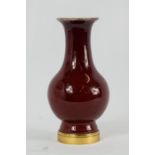 A 'Sang de Boeuf' red glazed Chinese 18th century baluster vase, of small proportions, a label to