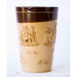 A Doulton Lambeth glazed stoneware jar/mug, embossed with figures drinking and hounds, impressed