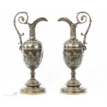 A pair of rare bronze classical ewers.