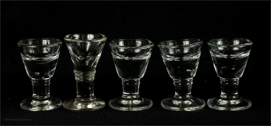 A group of five glass penny licks.