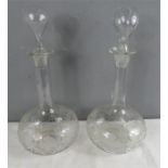 A pair of Edwardian decanters with original stoppers and etched decoration.[All proceeds of sale for