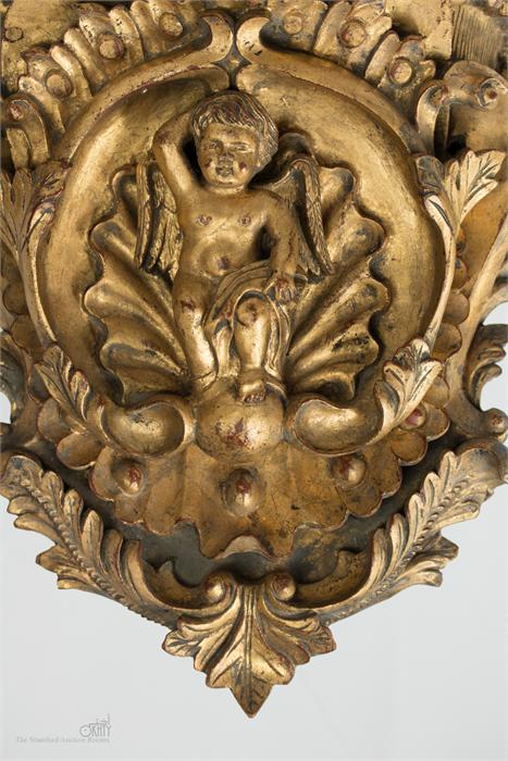 A pair of carved giltwood wall brackets, with cherubs to the centre. - Image 2 of 3