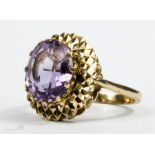 A 9ct and amethyst ring, with textured gold surround.