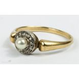 A gold and diamond ring, set with pearl to the centre and old cut diamond.