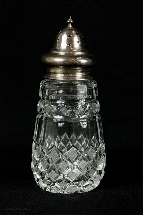 A silver top and cut glass sifter.