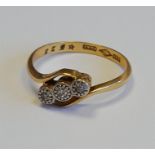 An 18ct gold ring with three diamond setting, 3.2g.