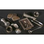 Three silver wine labels, pair of Orkney silver napkin rings, silver photograph frame, salt,