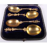 Victorian Indian gilt metal set of four serving spoons, maker P.