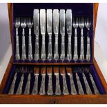 Edwardian oak cased silver canteen of fish knives and forks, Sheffield 1907, maker G H.