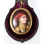 19th century painted porcelain brooch, depicting a young woman in a headscarf and Arabic jewellery,
