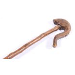 19th century chip carved walking stick, the swan neck handle carved with serpent and bird,