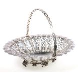 Victorian and silver pierced basket with swing handle and raised on c-scroll feet, makers Martin,