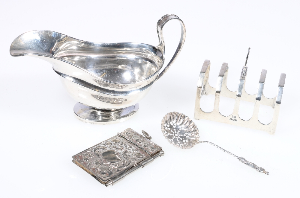Silver boat shaped sauce boat, on oval foot, 125g, 9cm, a four-division toastrack, 50g, 7.