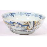 18th century Dutch Delft bowl with Chinoiserie decoration of figures in a watery landscape, 23cm.