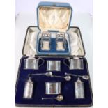 George V silver six-piece cruet set of oval form, together with a four-division toastrack,