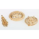 Three small carved ivory pieces, scene with grey hounds, wheatsheaf and a dog's head.