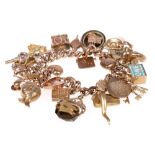 9ct gold charm bracelet with twenty-eight charms,