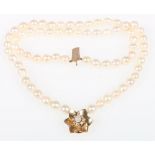 Natural pearl double strand necklet with paste and pearl set flowerhead clasp,