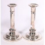 Pair of Elkington silver plated column candlesticks, with engraved crest, date letter C, 23cm.