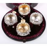 Victorian cased set of four silver salts, on ball feet, with three shell spoons, Birmingham 1888,