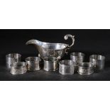 Silver sauce boat, 9cm and seven silver napkin rings,