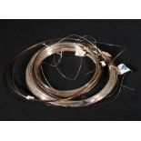 Three coils of white metal wire, makers J Mathey & Co,