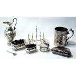 Indian silver embossed jug, a similar EP mug, a toast rack, a purse,