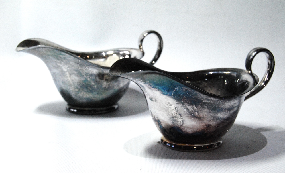 Pair of silver sauce boats of very plain form with flared hips,