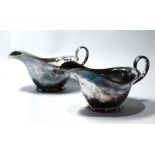 Pair of silver sauce boats of very plain form with flared hips,