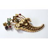 Continental gold brooch of cornucopia form with zircon, rubies and garnets.