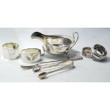 Silver sauce boat, four napkin rings, a pickle fork and tongs, gross 9½oz.
