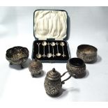 Three Indian silver embossed condiments, two similar bowls and six coffee spoons, cased.