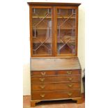 George III mahogany bureau bookcase, the bureau with well interior, 107cm wide and 214cm high.