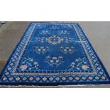 Chinese carpet with medallion and floral sprays on a blue ground, 307cm x 206cm.