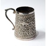 Indian silver mug of tapering form, embossed with animals and scrolls, 6½oz.