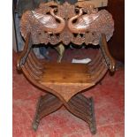 Continental X-frame chair, the back carved with a peacock.