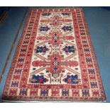 Caucasian Kazak style rug with three stars on an ivory field, 206cm long and 116cm wide.