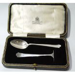 Silver spoon and pusher, cased.