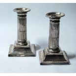 Pair of silver boudoir candlesticks with fluted columns, Sheffield 1890, 13cm, loaded.